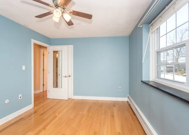 wooden floor in an empty room with a window