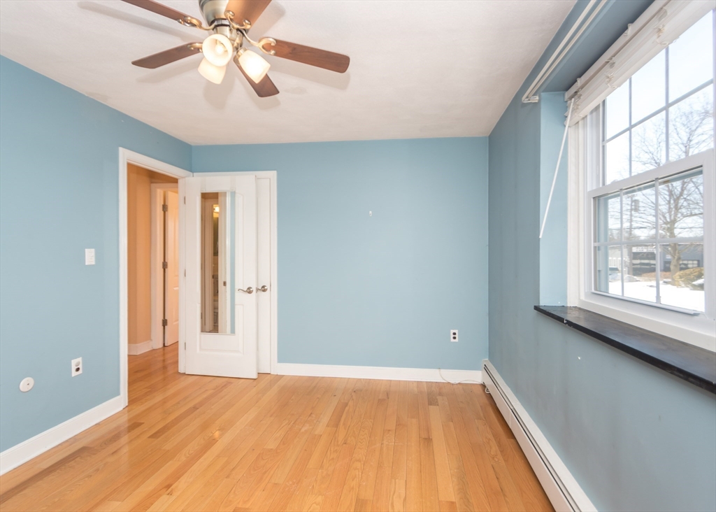 99 Pleasant Street, Unit 11 Watertown, MA 02472 - Photo 14 of 22 wooden floor in an empty room with a window