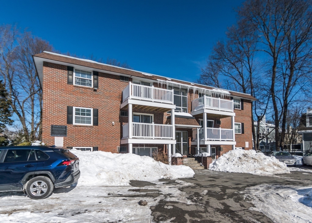 99 Pleasant Street, Unit 11 Watertown, MA 02472 - Photo 19 of 22 a front view of a house with a yard