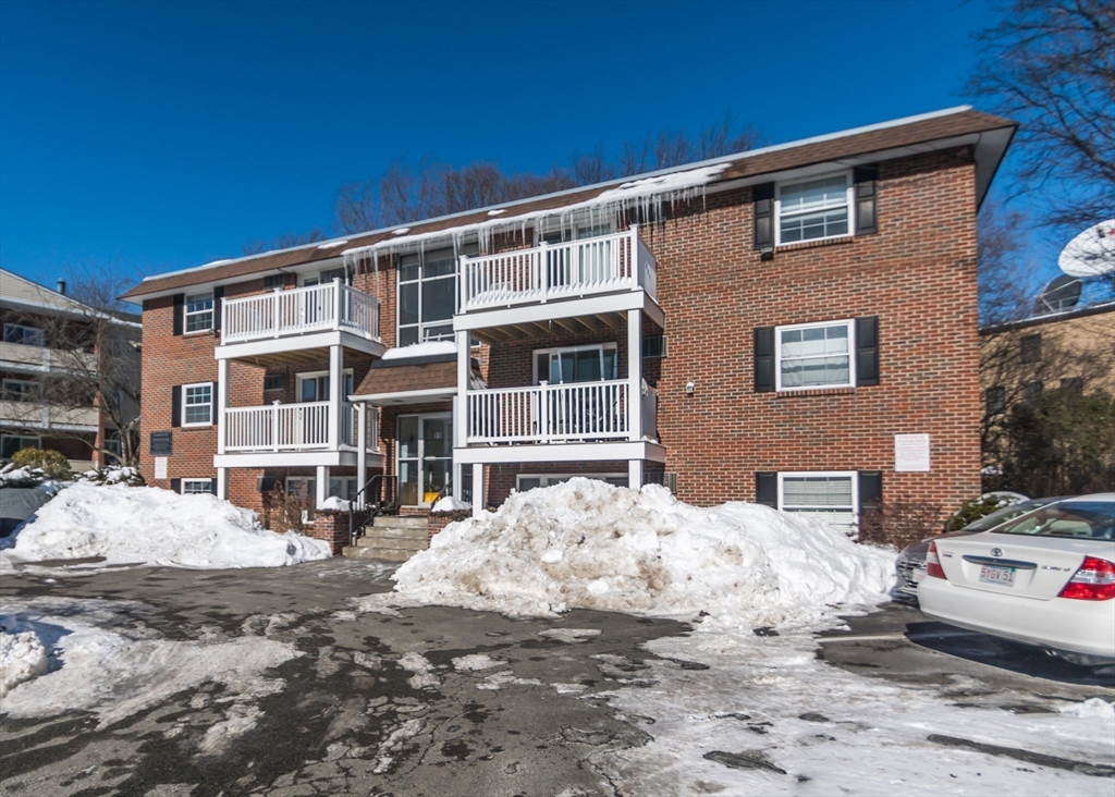 99 Pleasant Street, Unit 11 Watertown, MA 02472 - Photo 20 of 22 a front view of a house with a yard