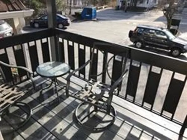 a view of a balcony with chairs
