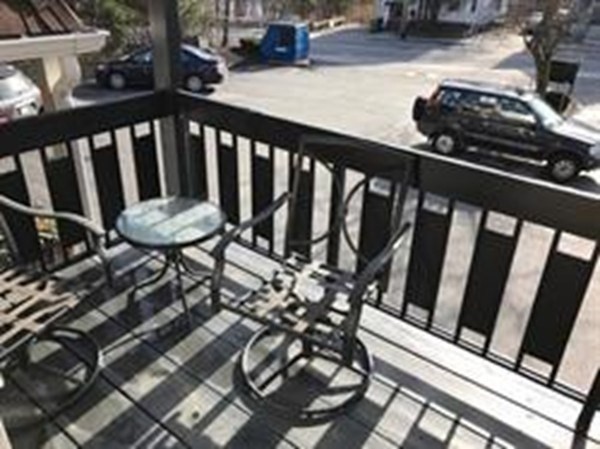 99 Pleasant Street, Unit 11 Watertown, MA 02472 - Photo 22 of 22 a view of a balcony with chairs