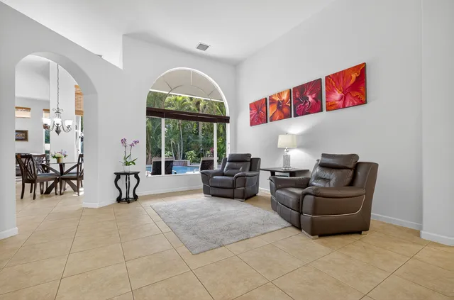 a dining room with furniture and large windows