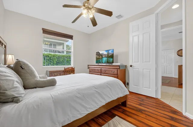 a bedroom with a bed window and a flat screen tv