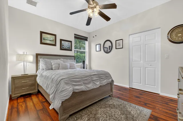 a bedroom with a large bed and a chandelier