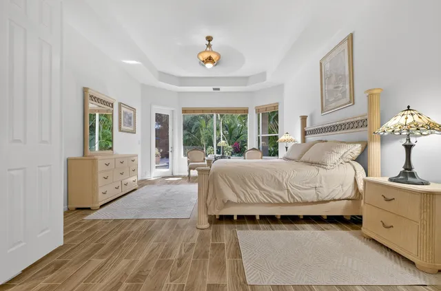 a spacious bathroom with a granite countertop sink a mirror a vanity and a bathtub