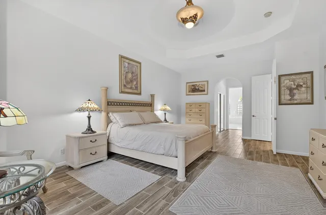 a spacious bathroom with a mirror and a sink