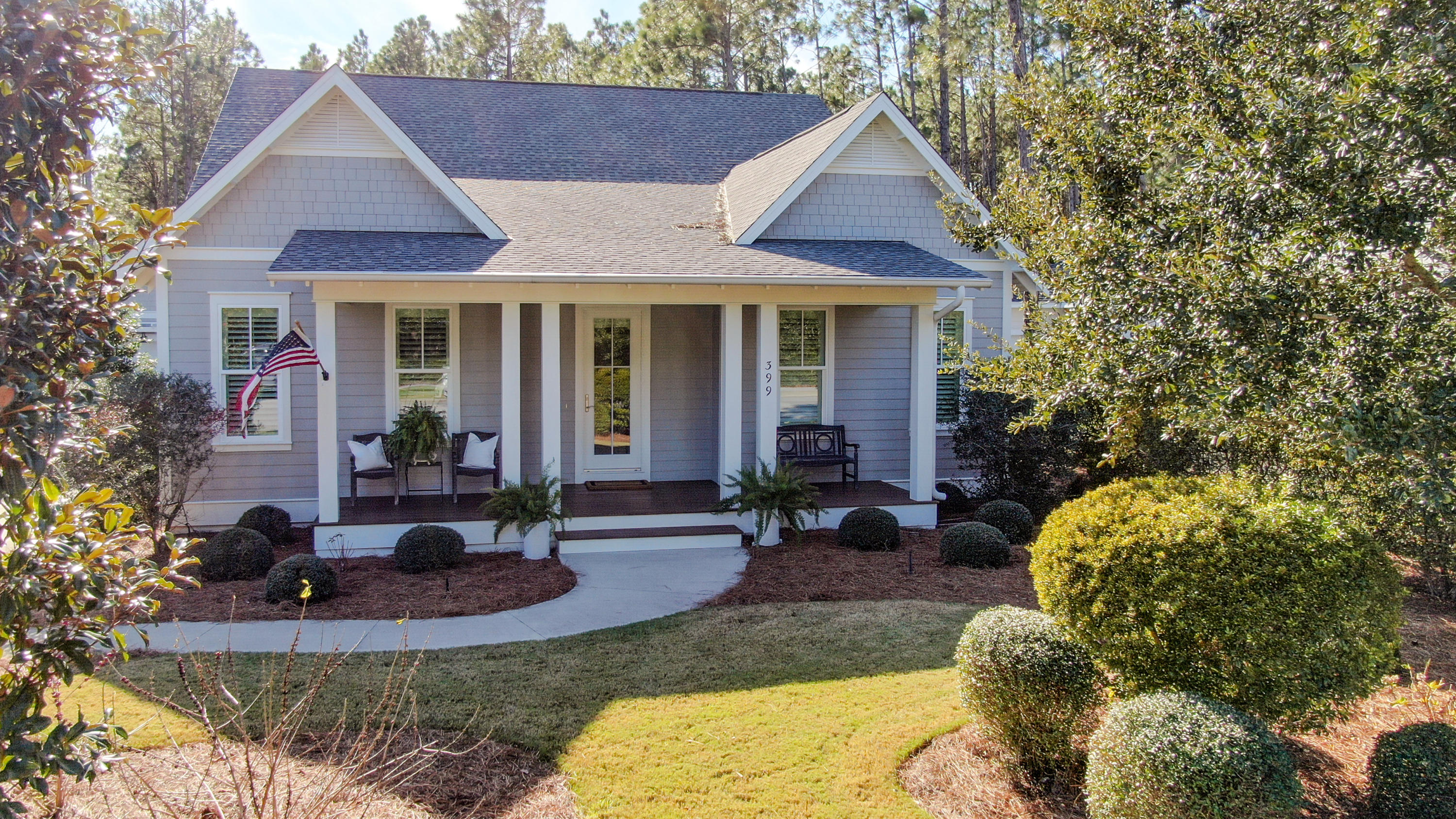 399 Medley Street Watersound, FL 32461 - Photo 2 of 30 a front view of a house with garden