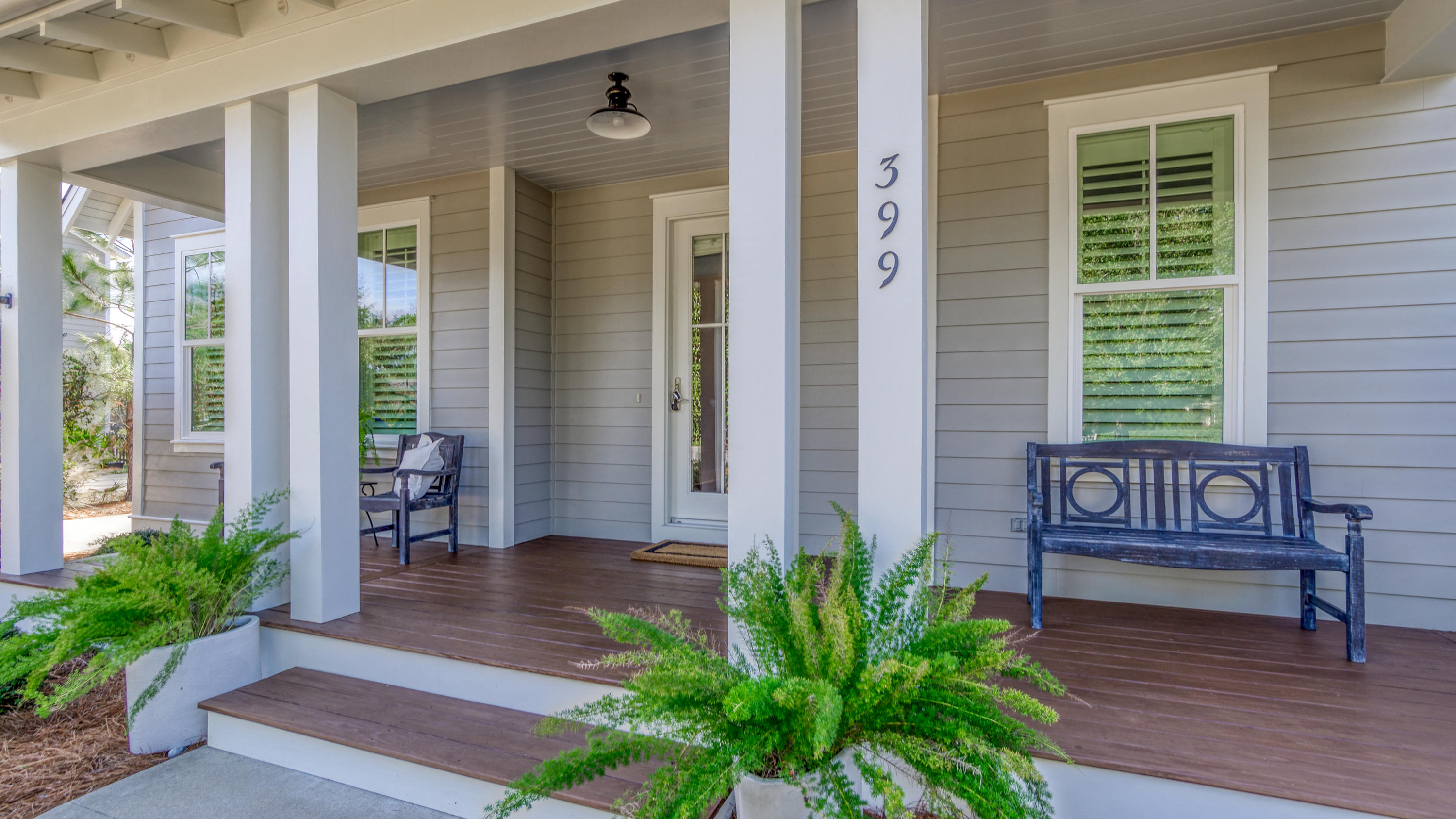 399 Medley Street Watersound, FL 32461 - Photo 3 of 30 a view of a house with porch and wooden bench