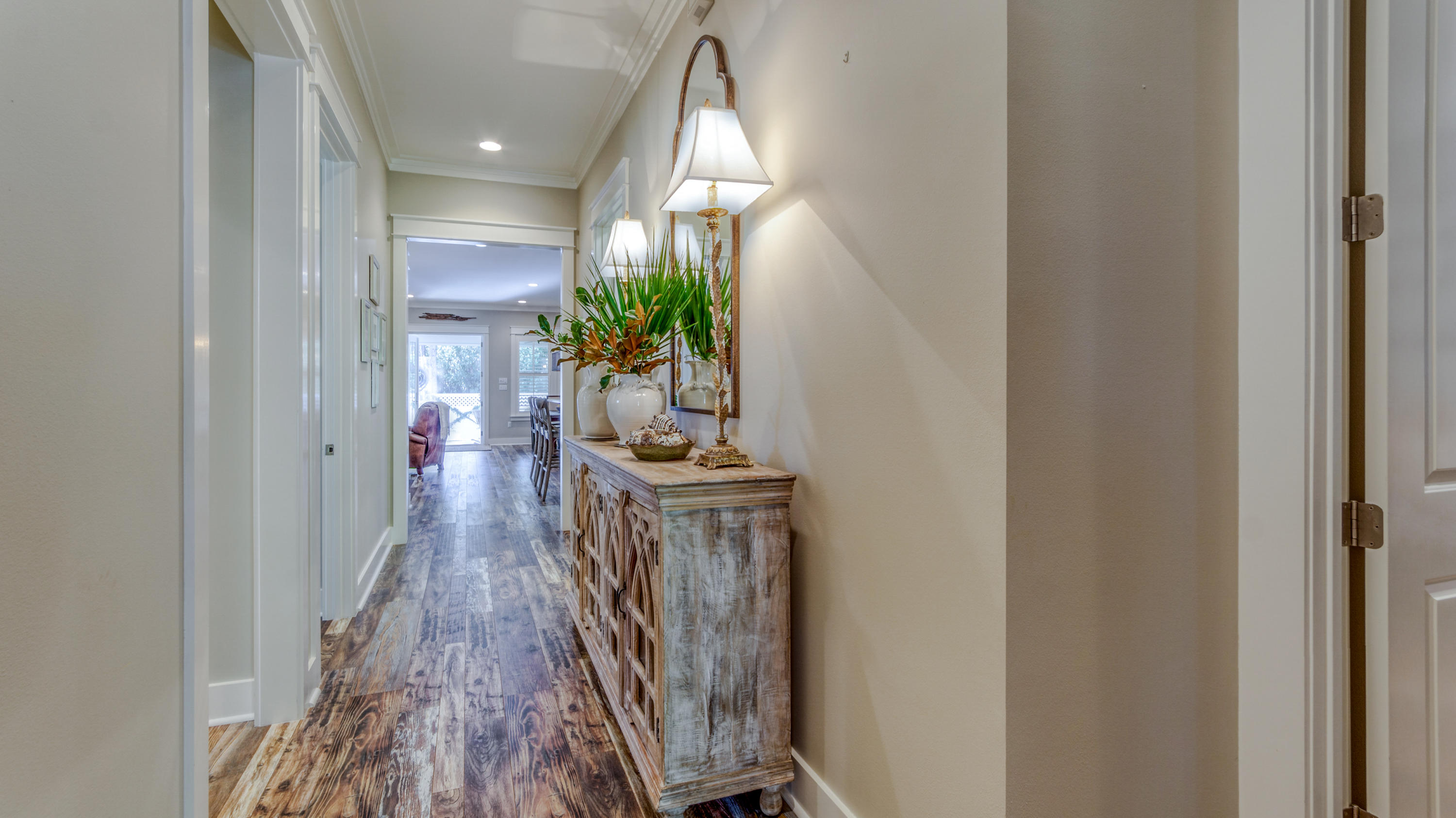 399 Medley Street Watersound, FL 32461 - Photo 5 of 30 a hallway with a potted plant on a dresser