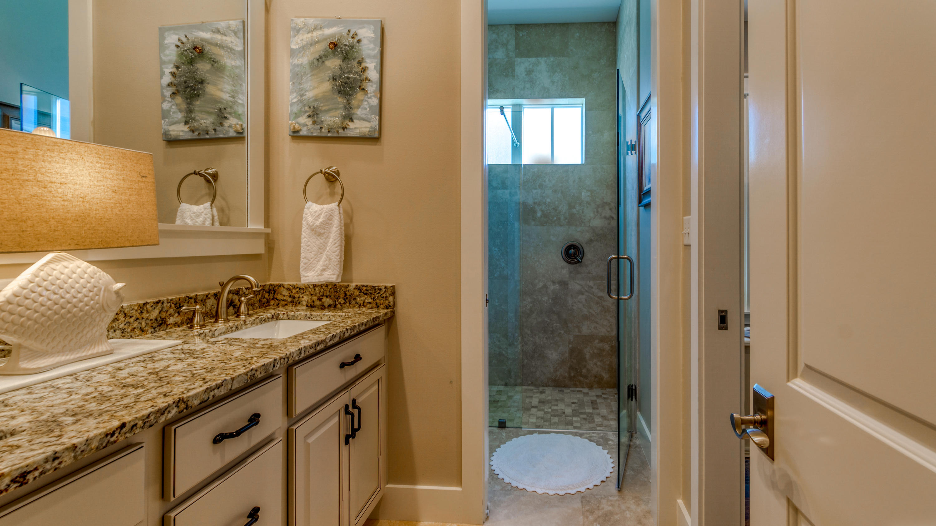 399 Medley Street Watersound, FL 32461 - Photo 7 of 30 a bathroom with a granite countertop sink toilet and shower