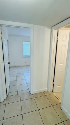 a view of an empty room and a window