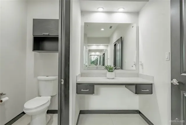 a bathroom with a sink a toilet and mirror