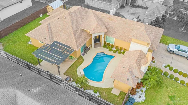 an aerial view of a house with a swimming pool