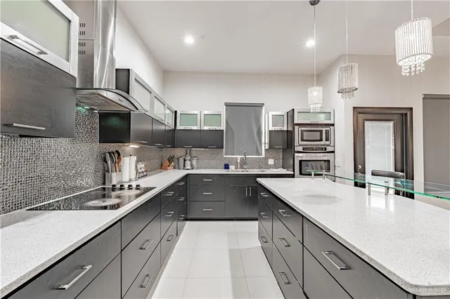a large kitchen with a sink and cabinets