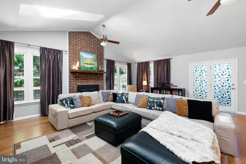 a living room with furniture a large window and a flat screen tv