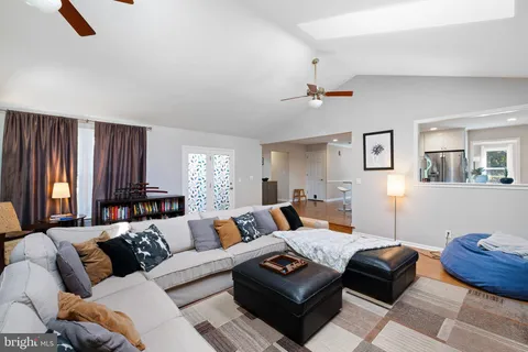 a living room with furniture a rug and a window