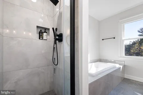 a bathroom with a tub and shower