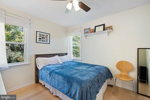 a bedroom with a bed chair and window