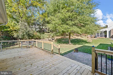 a view of a balcony with wooden floor and fence