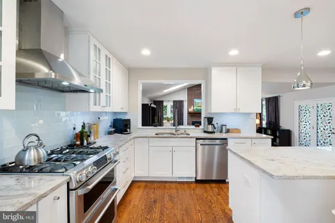a kitchen with stainless steel appliances granite countertop a stove and a sink