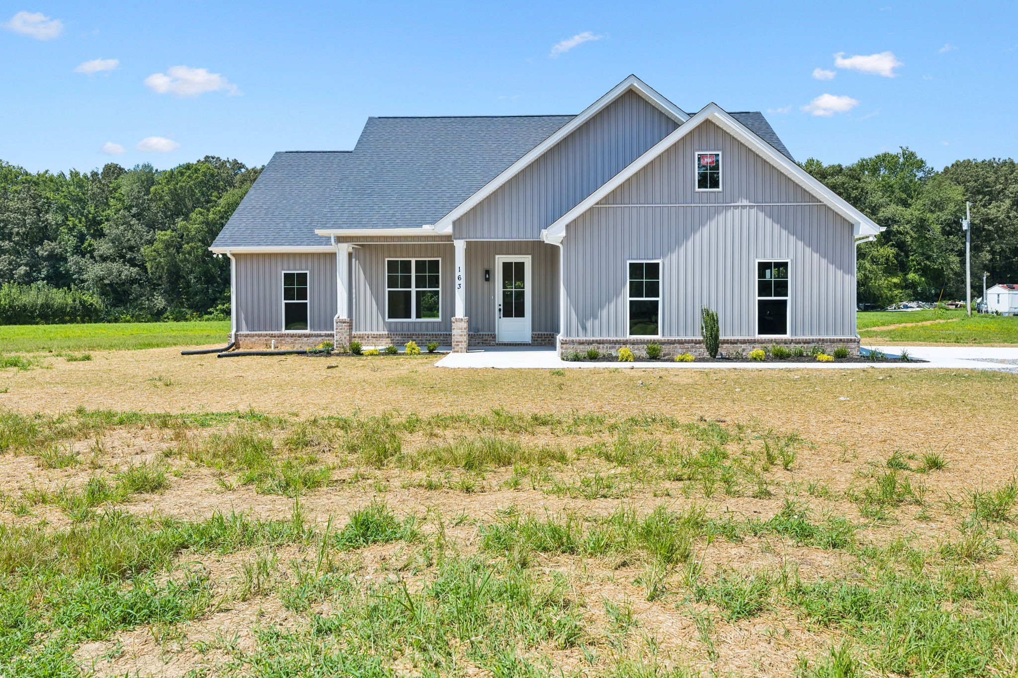 a front view of house with yard and green space