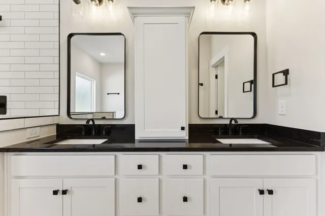 a bathroom with mirror and