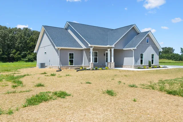 a view of yellow house with a swimming pool