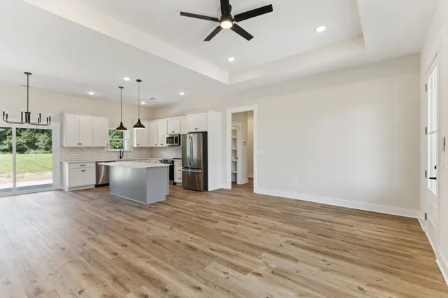 a view of a kitchen with a sink and wooden floor