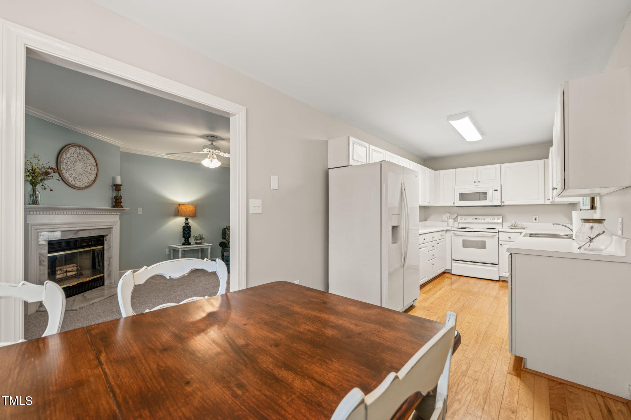 2102 Trailridge Court Raleigh, NC 27603 - Photo 14 of 28 a kitchen with a refrigerator a stove top oven and a sink