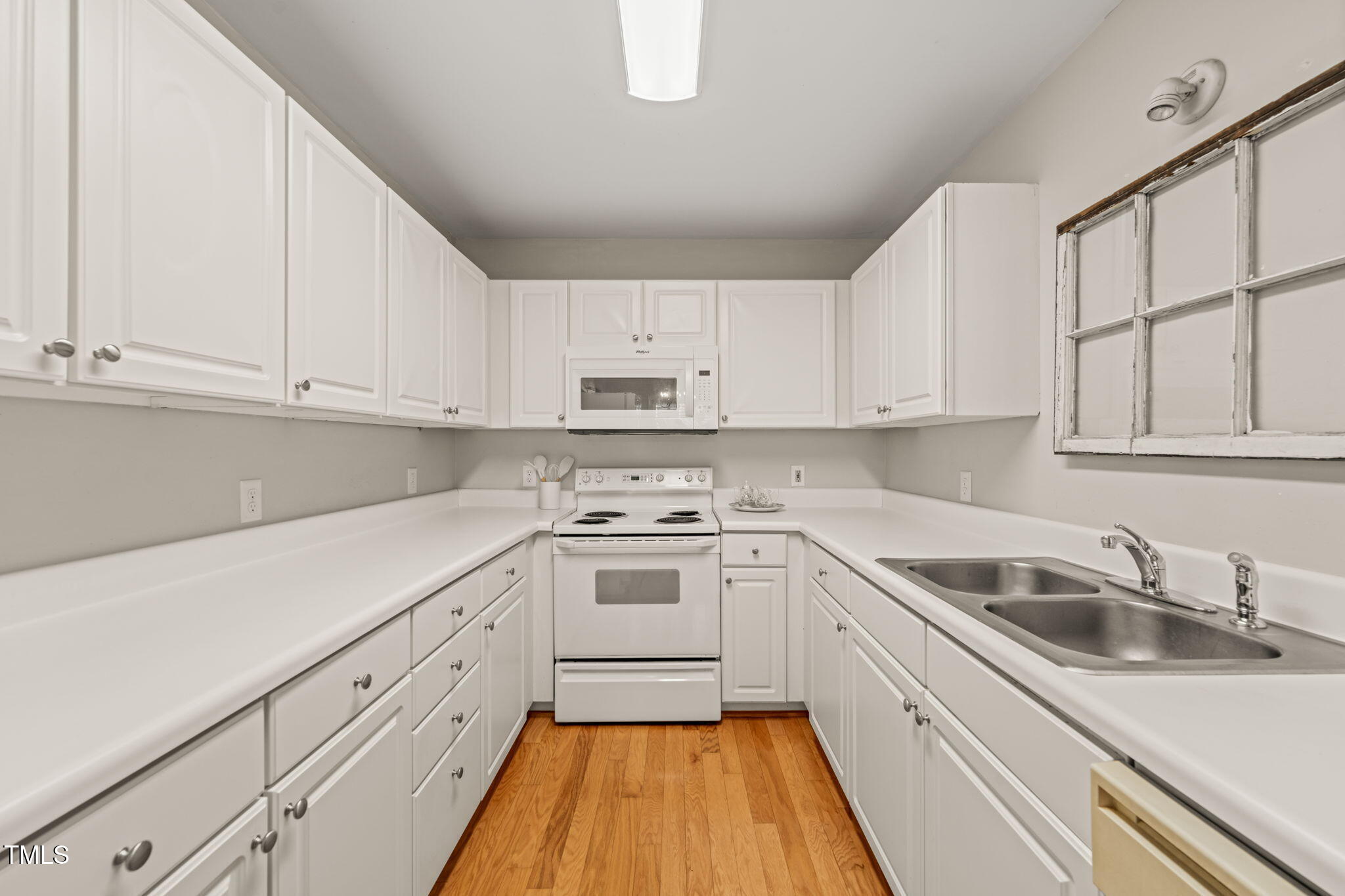 2102 Trailridge Court Raleigh, NC 27603 - Photo 16 of 28 a kitchen with granite countertop white cabinets and white appliances