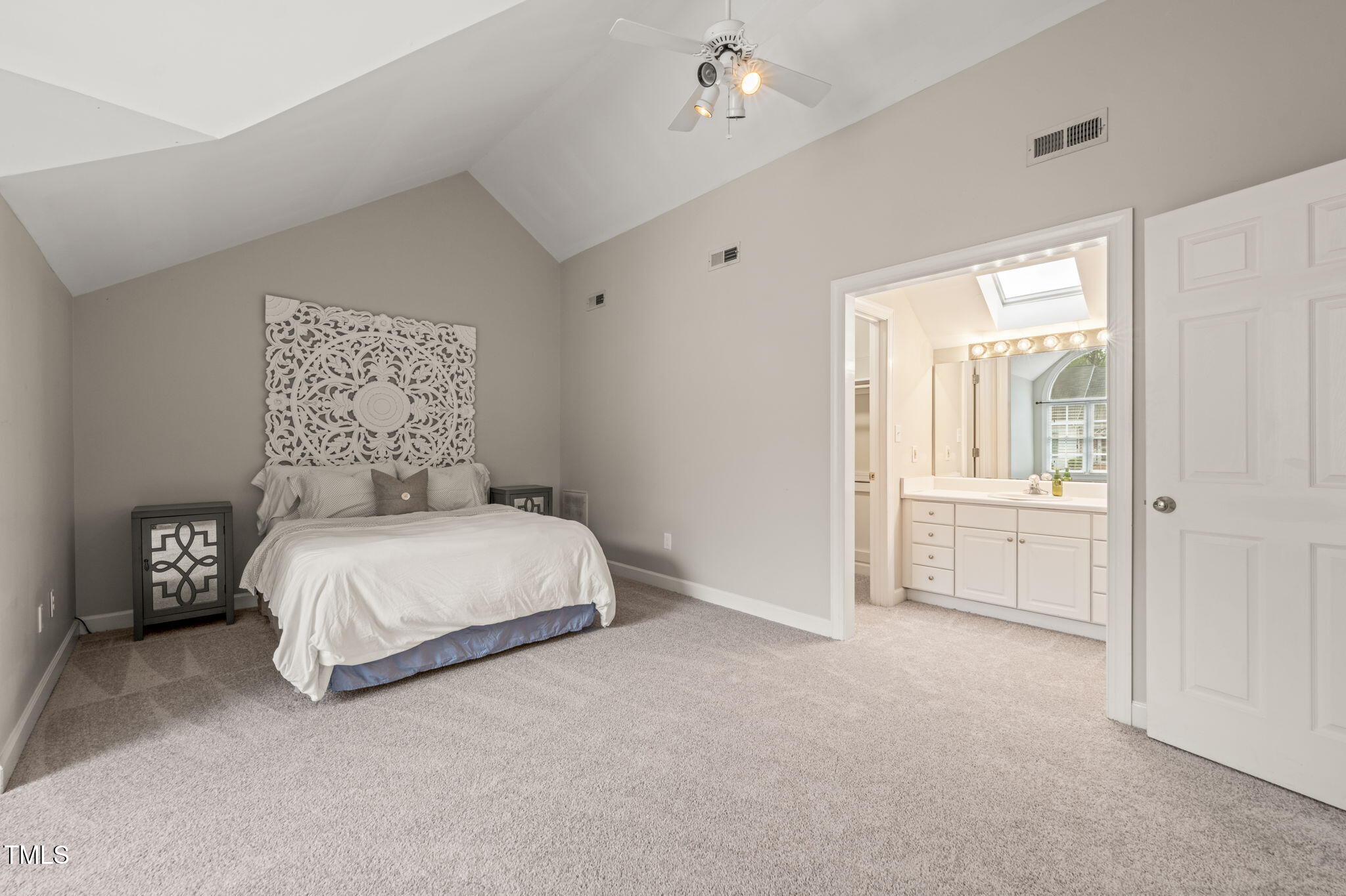 2102 Trailridge Court Raleigh, NC 27603 - Photo 20 of 28 a bedroom with a bed and a chandelier