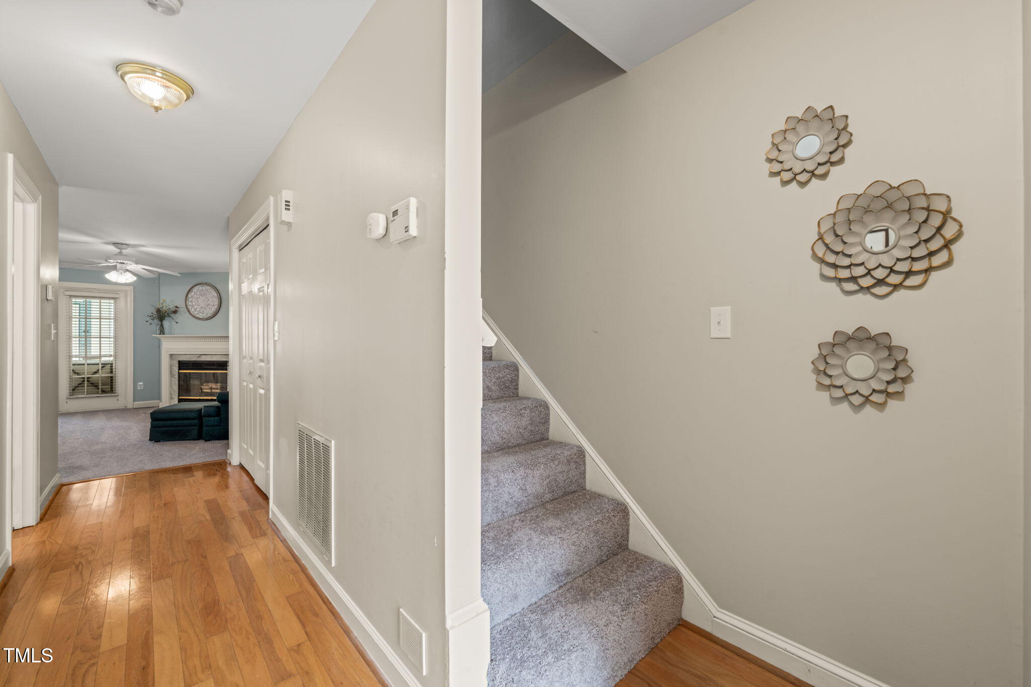 2102 Trailridge Court Raleigh, NC 27603 - Photo 4 of 28 a view of a hallway with wooden floor and staircase