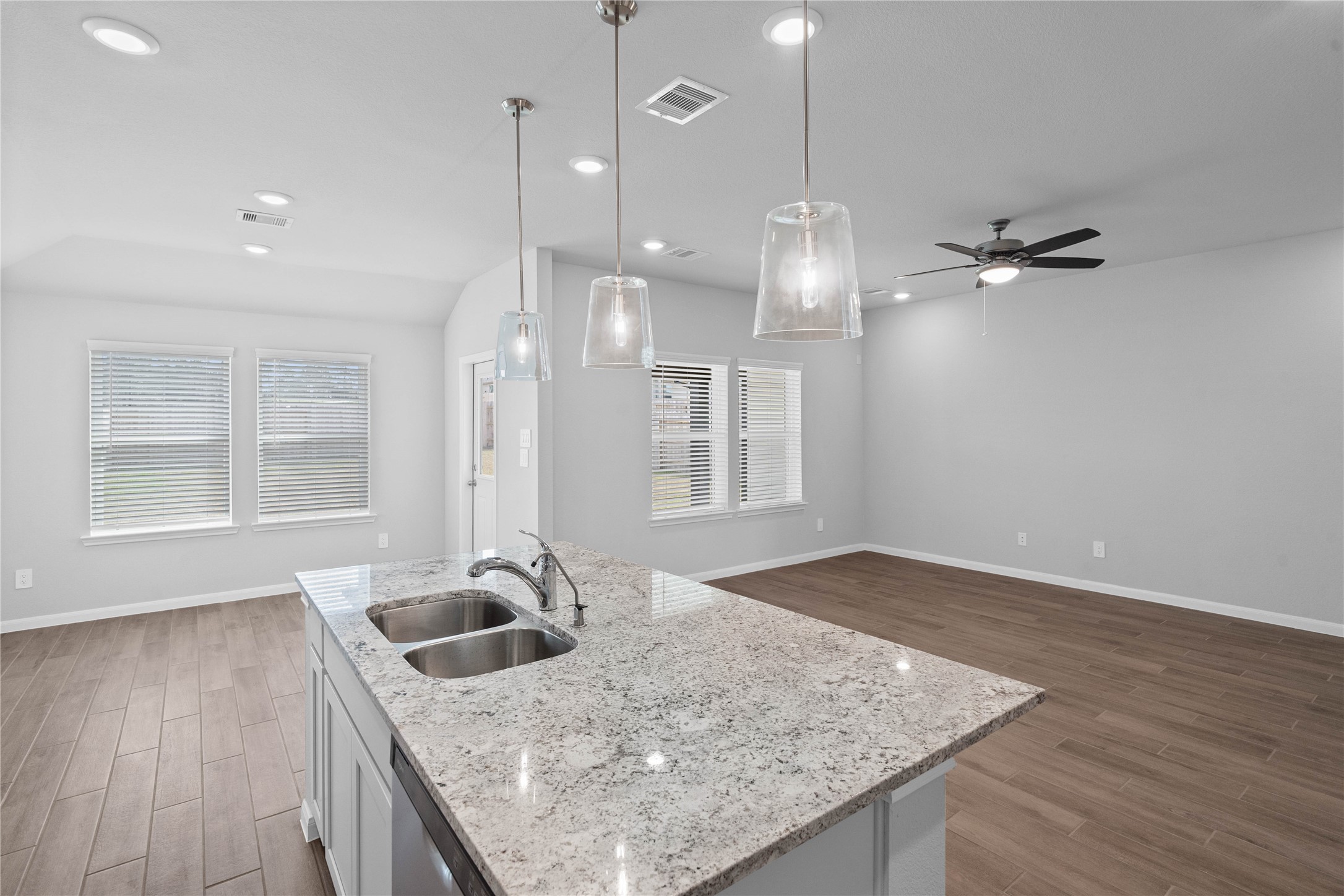 19645 Montgomery Rdg Way Montgomery, TX 77316 - Photo 22 of 41 From the expansive kitchen island, enjoy seamless sightlines across the open-concept dining and living areas, making entertaining a breeze and ensuring you're never far from the conversation.