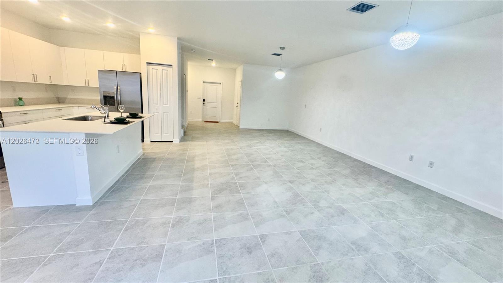 19479 Southwest 340th Street, Unit 1 Homestead, FL 33034 - Photo 40 of 58 a large kitchen with cabinets