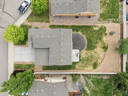 an aerial view of a house with a yard and a fountain