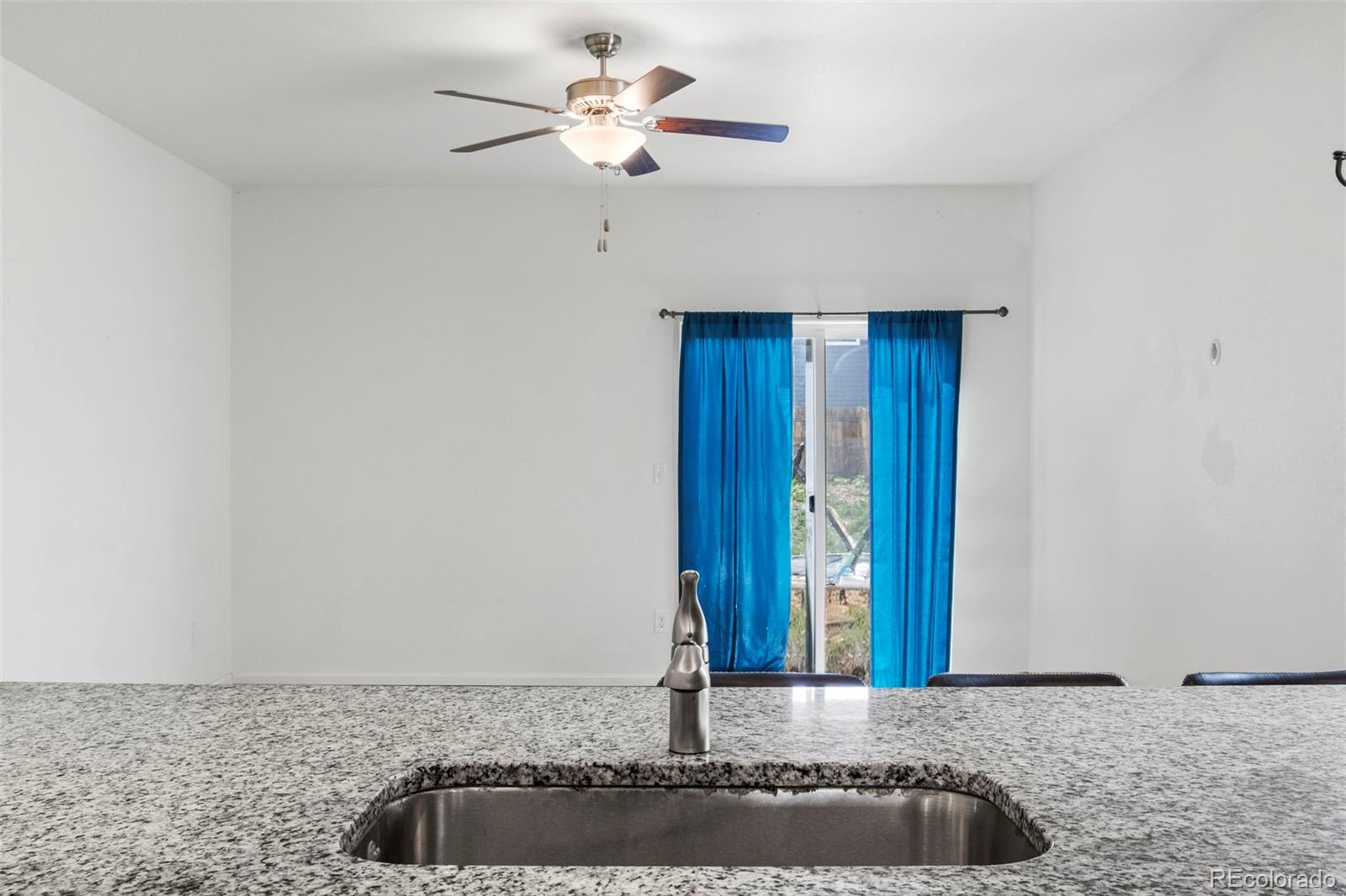 311 Maple Street Bennett, CO 80102 - Photo 12 of 35 a view of a chandelier fan in a room