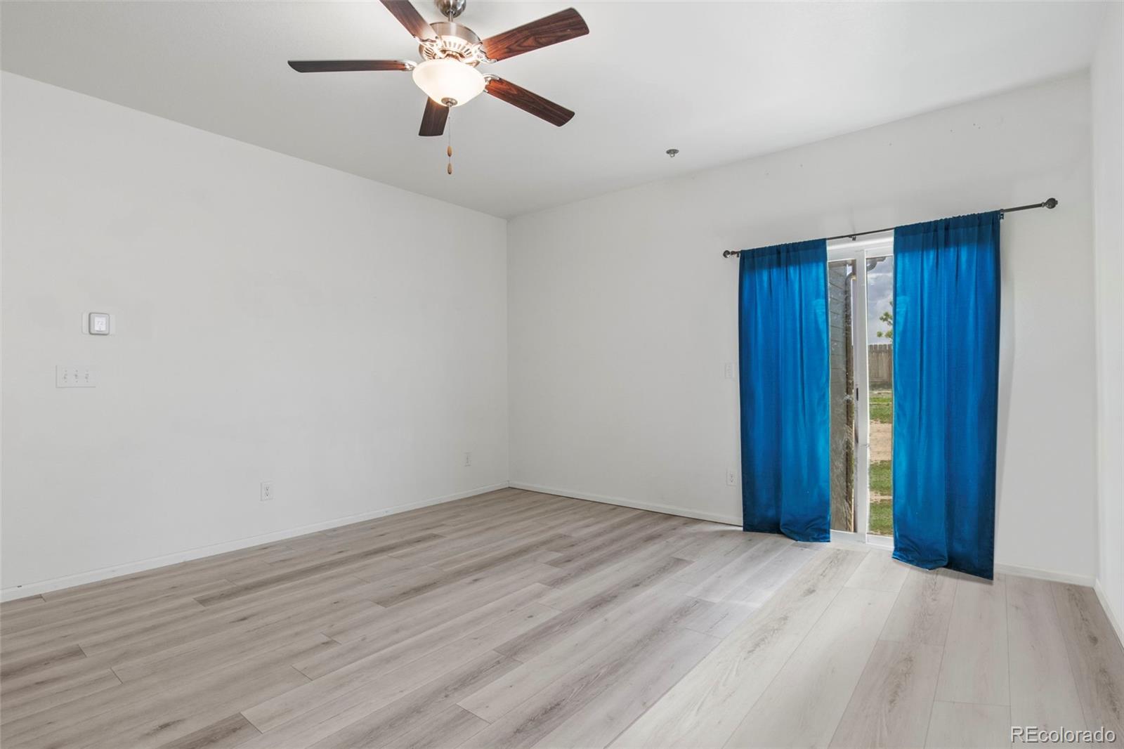 311 Maple Street Bennett, CO 80102 - Photo 16 of 35 a view of empty room with wooden floor