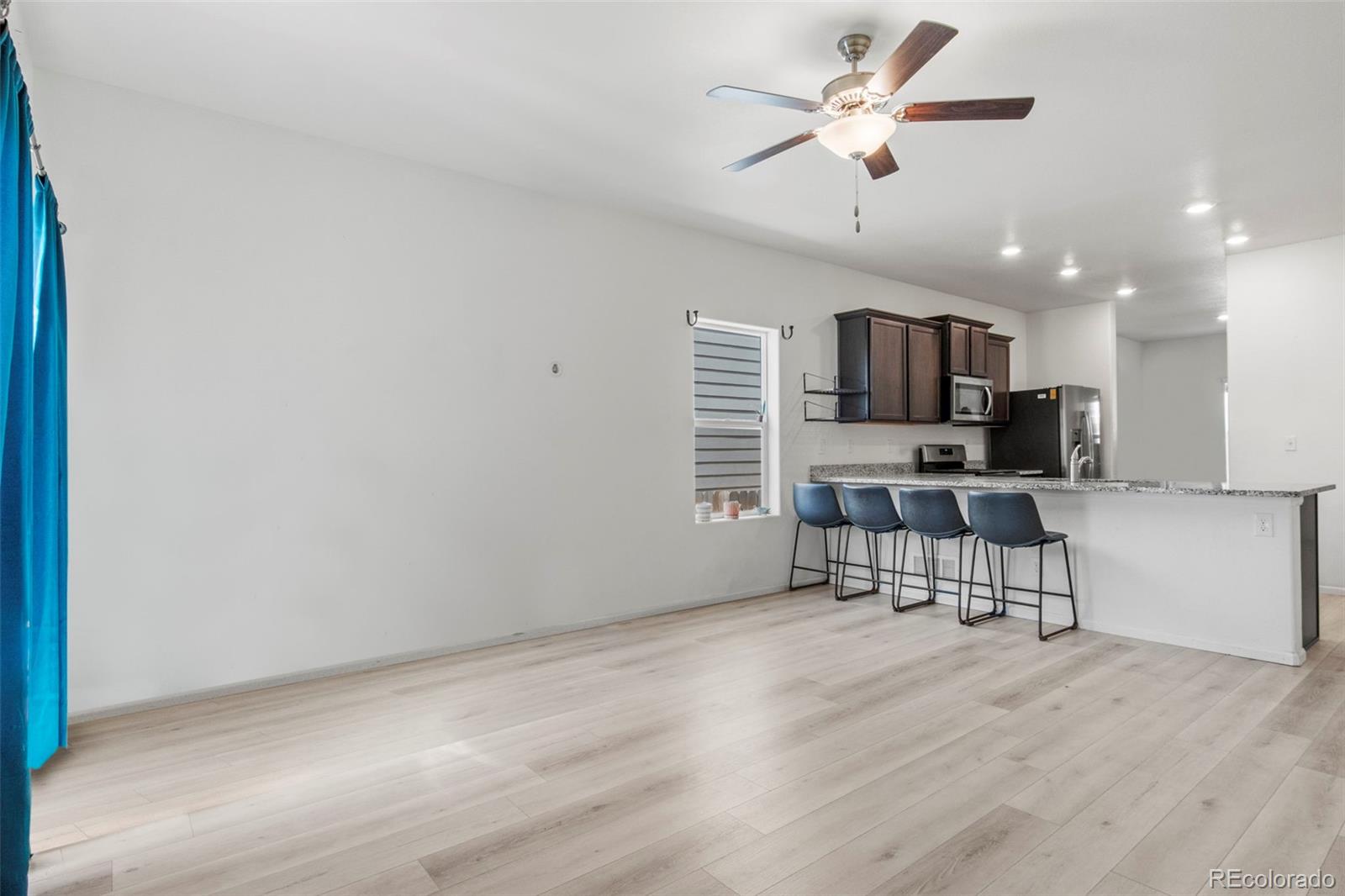 311 Maple Street Bennett, CO 80102 - Photo 17 of 35 a living room with furniture and a flat screen tv
