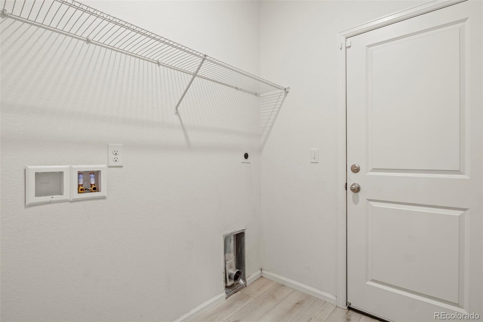 311 Maple Street Bennett, CO 80102 - Photo 18 of 35 a room that has a glass shower door