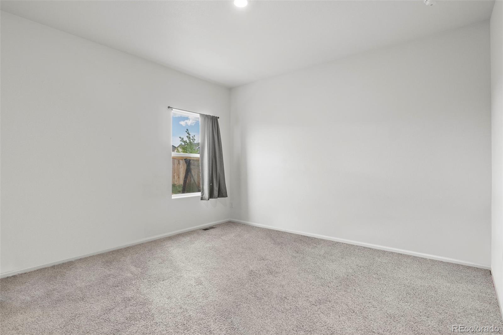 311 Maple Street Bennett, CO 80102 - Photo 19 of 35 an empty room with windows
