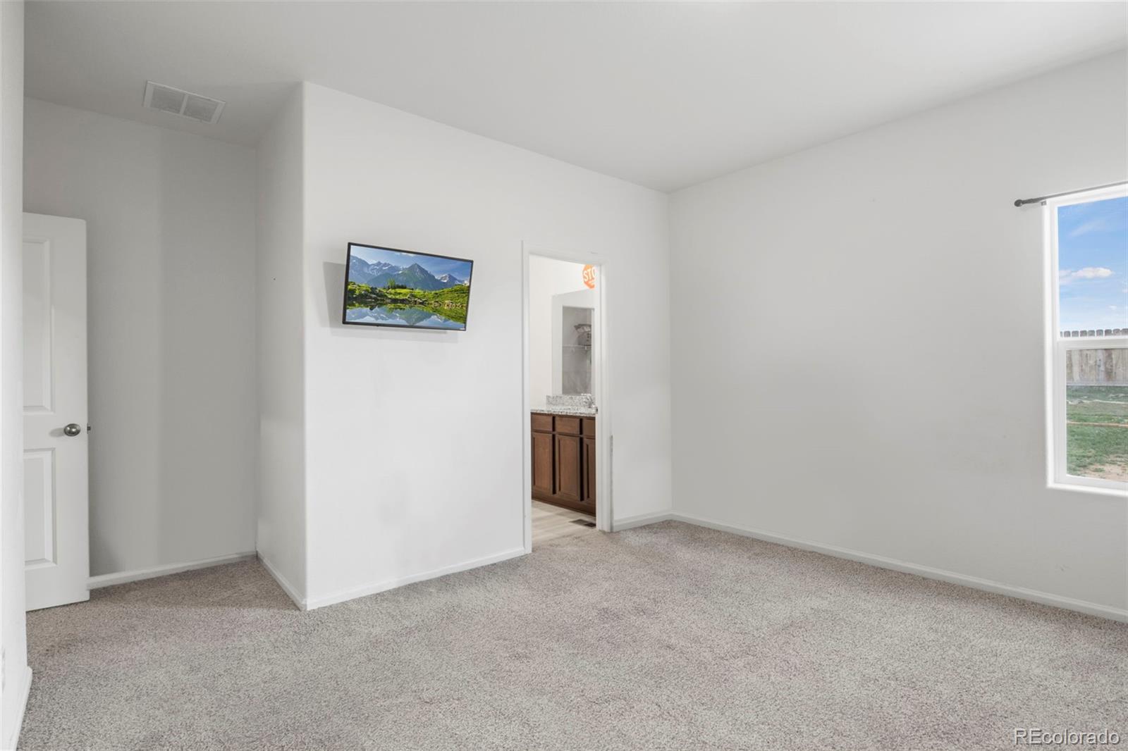 311 Maple Street Bennett, CO 80102 - Photo 20 of 35 an empty room with windows and closet