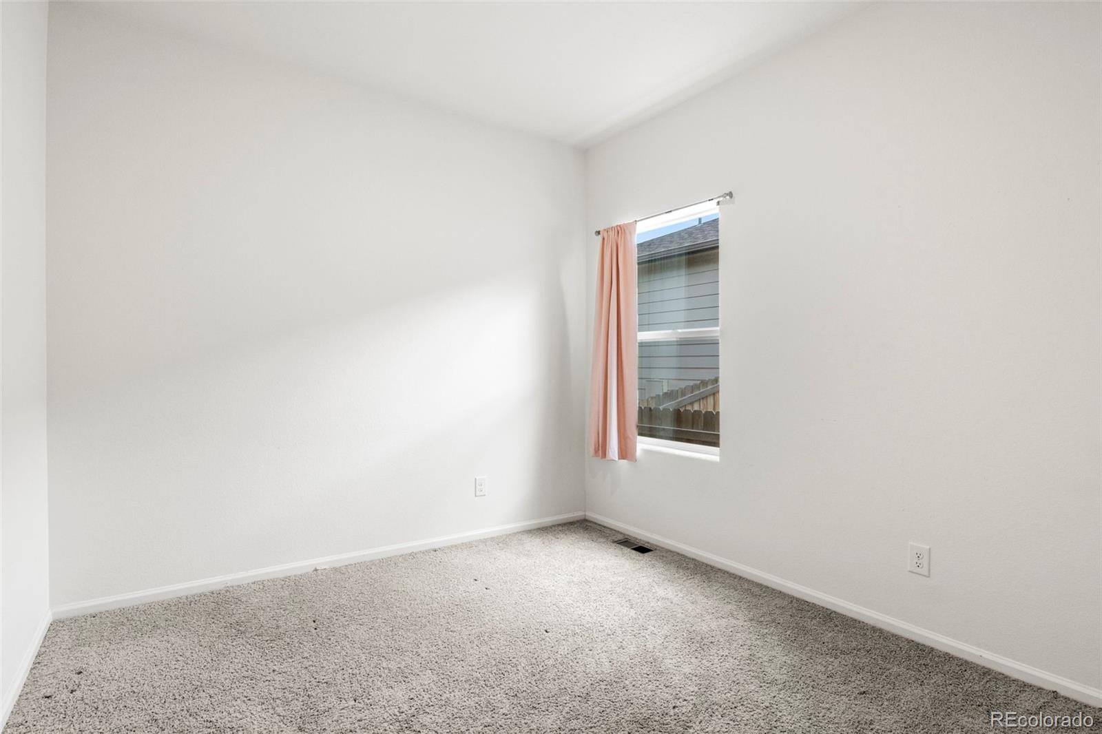 311 Maple Street Bennett, CO 80102 - Photo 25 of 35 an empty room with a window