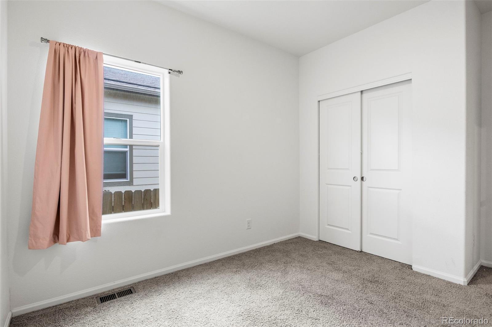311 Maple Street Bennett, CO 80102 - Photo 26 of 35 a view of an empty room with a window