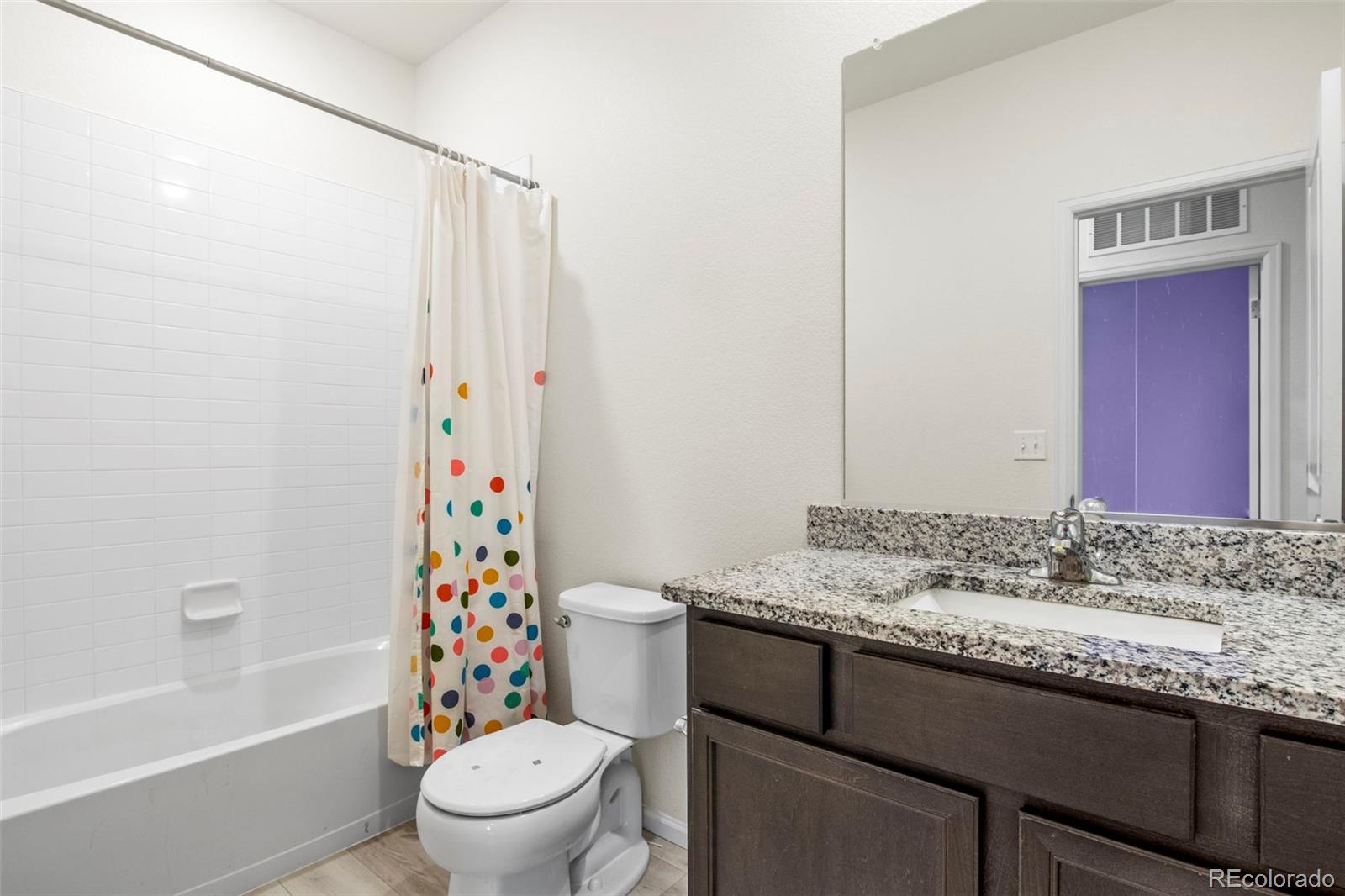 311 Maple Street Bennett, CO 80102 - Photo 28 of 35 a bathroom with a granite countertop sink a toilet and shower
