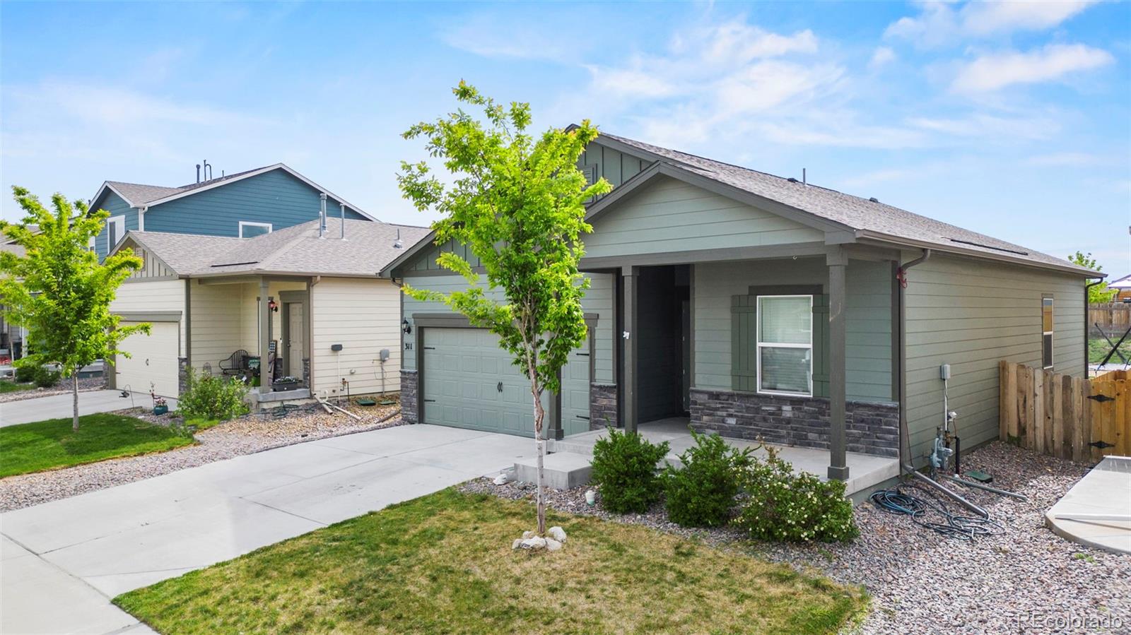 311 Maple Street Bennett, CO 80102 - Photo 3 of 35 a front view of a house with garden