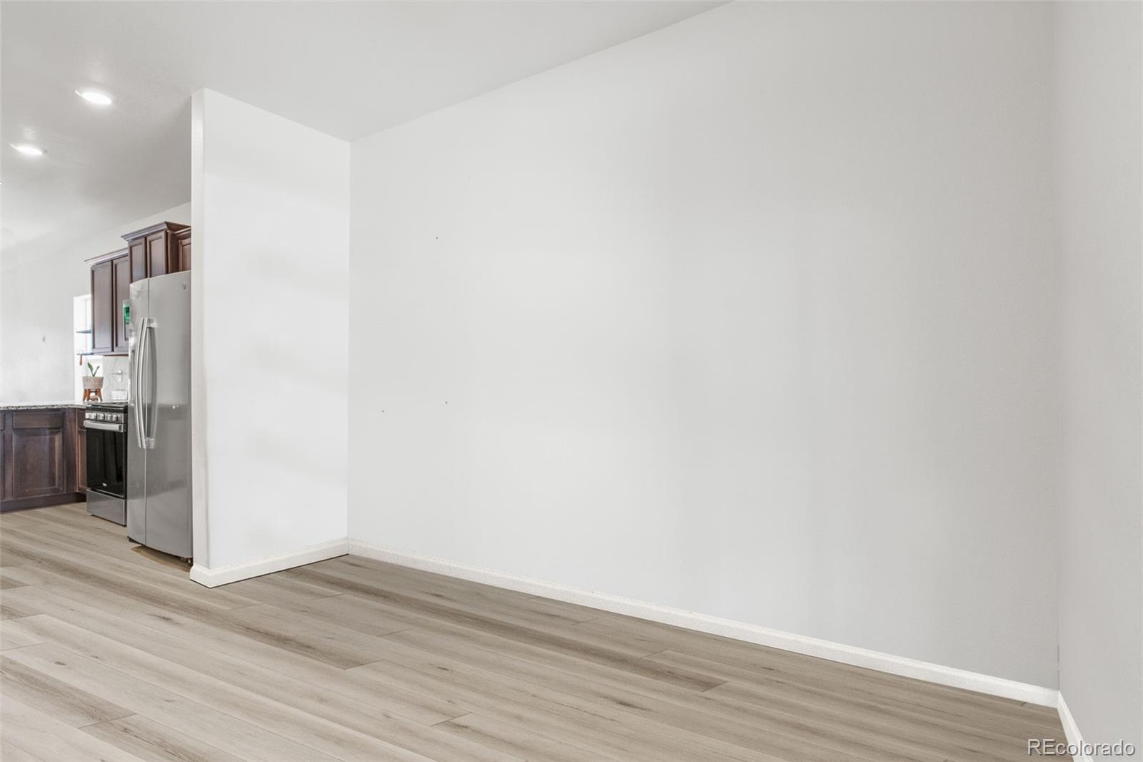 311 Maple Street Bennett, CO 80102 - Photo 9 of 35 a view of empty room with wooden floor