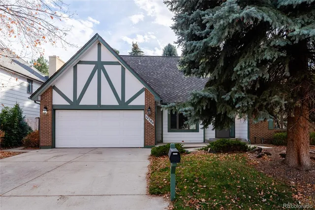 a front view of a house with yard and garage