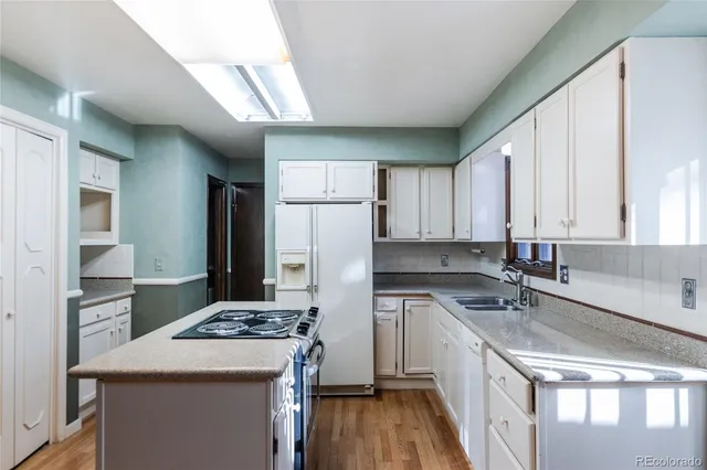 a kitchen with a sink stove and refrigerator