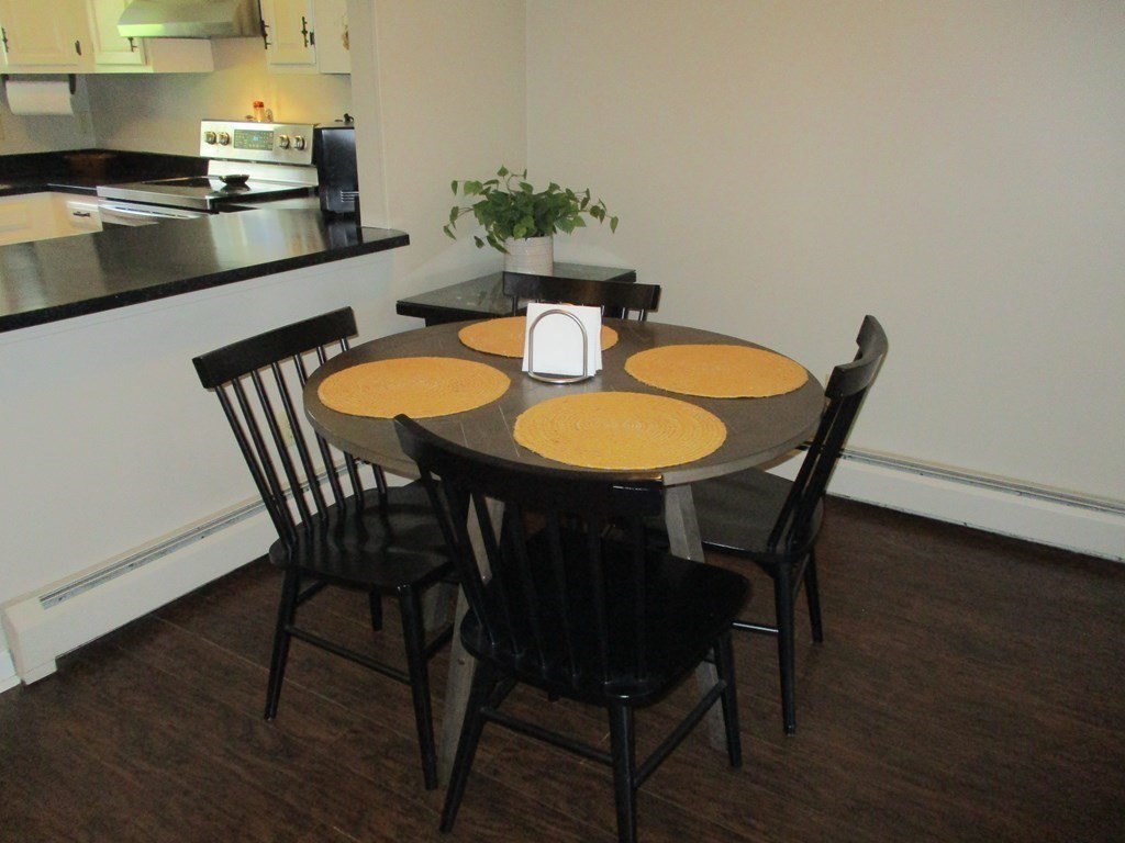 2 Tuck Farm Road, Unit 5 Auburn, MA 01501 - Photo 6 of 11 a dining room with furniture and wooden floor